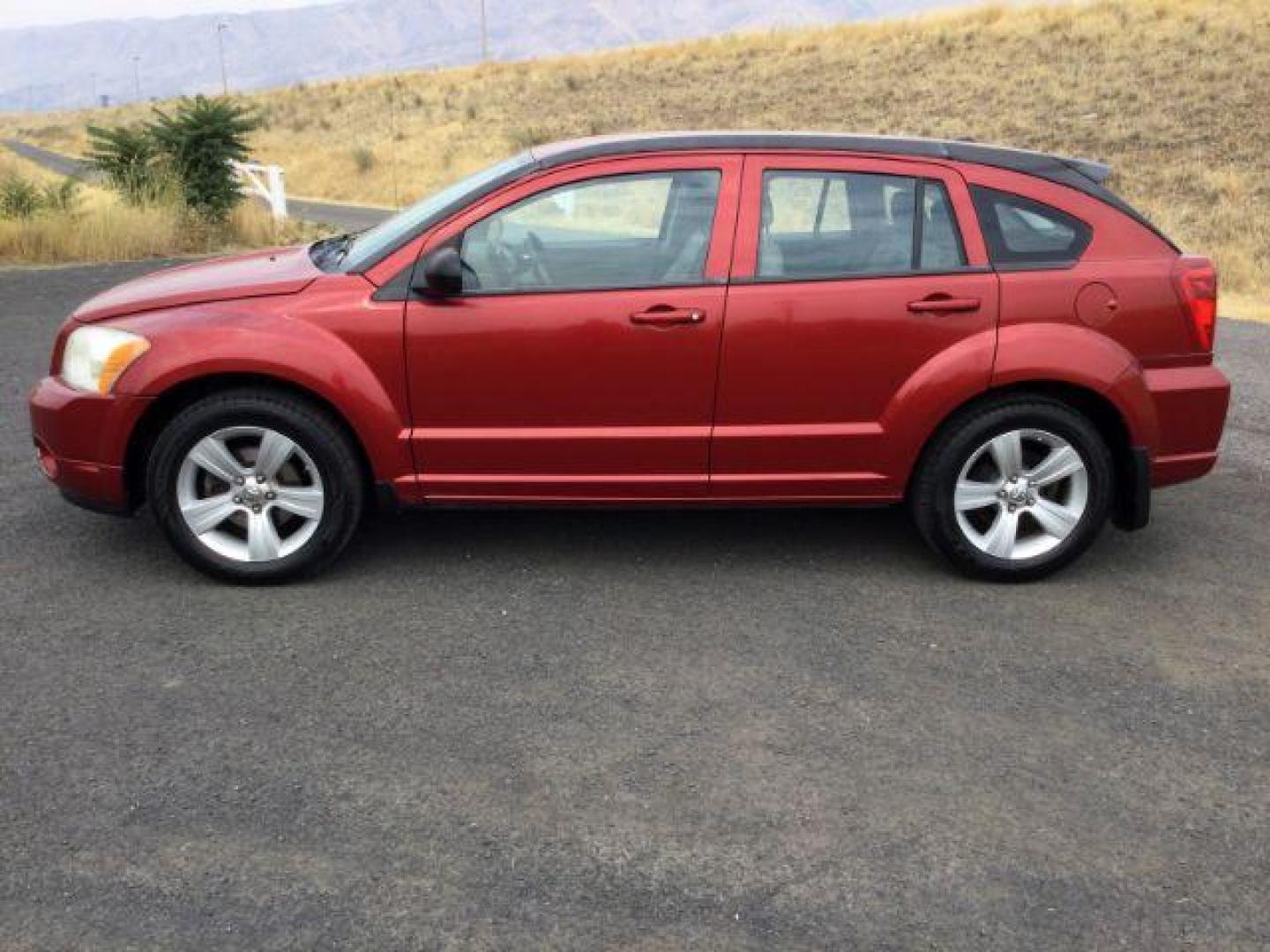 2010 Inferno Red Crystal Pearlcoat /Dark Slate/Medium Graystone Leather Interior Dodge Caliber Uptown (1B3CB9HB9AD) with an 2.4L L4 DOHC 16V engine, Continuously Variable Transmission transmission, located at 1801 Main Street, Lewiston, 83501, (208) 743-9371, 46.417065, -117.004799 - Photo#1