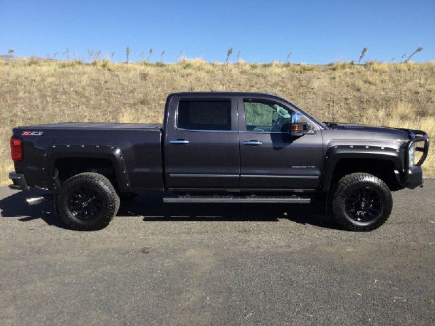 2015 Tungsten Metallic /Jet Black/Dark Ash Chevrolet Silverado 3500HD LTZ Crew Cab 4WD (1GC4K0C80FF) with an 6.6L V8 OHV 32V TURBO DIESEL engine, 6-Speed Automatic transmission, located at 1801 Main Street, Lewiston, 83501, (208) 743-9371, 46.417065, -117.004799- Photo#1