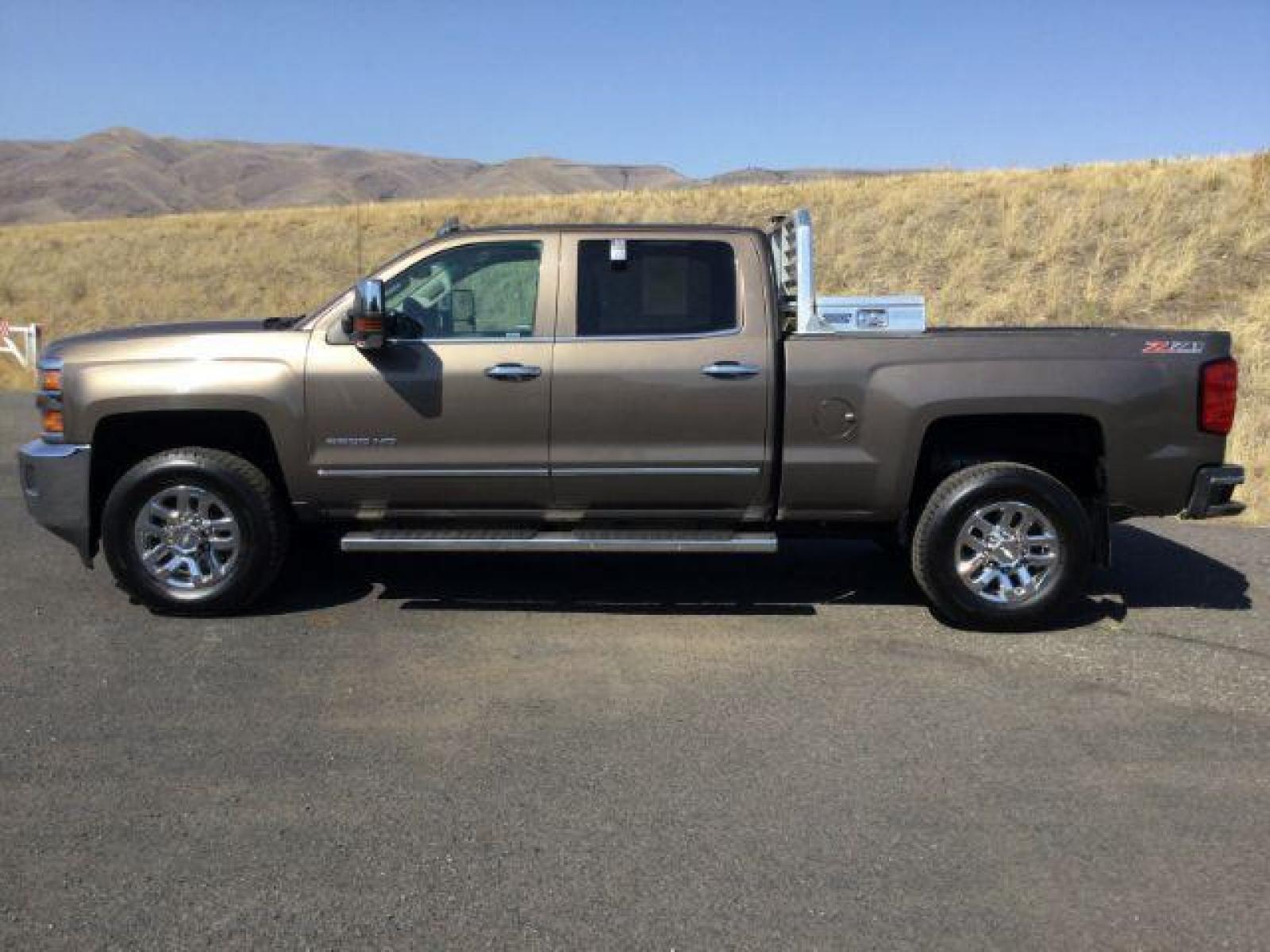 2015 Brownstone Metallic /Cocoa/Dune Chevrolet Silverado 3500HD LTZ Crew Cab 4WD (1GC1K0EG6FF) with an 6.0L V8 OHV 16V FFV engine, 6-Speed Automatic transmission, located at 1801 Main Street, Lewiston, 83501, (208) 743-9371, 46.417065, -117.004799 - Photo #1