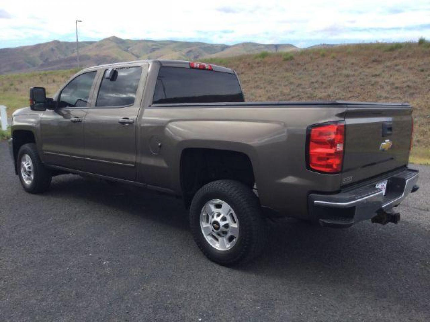 2015 Brownstone Metallic /Cocoa/Dune Chevrolet Silverado 2500HD LT (1GC1KVEGXFF) with an Vortec 6L V-8 variable valve control engine, 6-SPEED AUTOMATIC transmission, located at 1801 Main Street, Lewiston, 83501, (208) 743-9371, 46.417065, -117.004799 - Photo#1