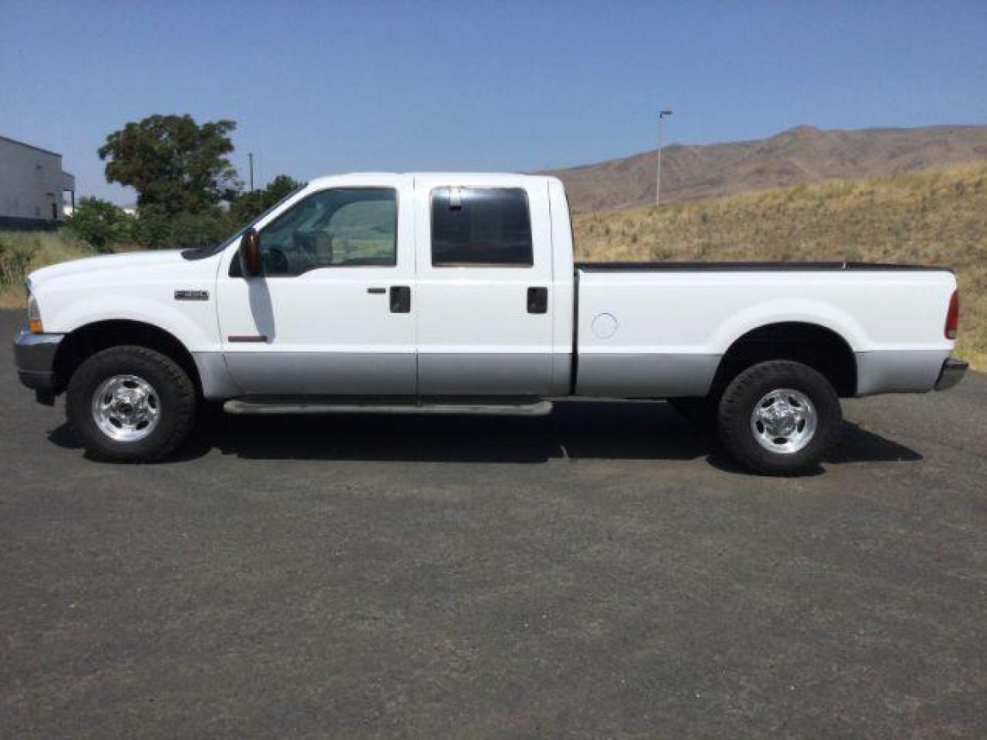 2004 Oxford White Clearcoat /Medium Flint Ford F-350 Lariat Crew Cab Long Bed 4WD (1FTSW31P74E) with an Powerstroke 6L V-8 diesel direct injection engine, 5-Speed Automatic transmission, located at 1801 Main Street, Lewiston, 83501, (208) 743-9371, 46.417065, -117.004799 - Photo#1