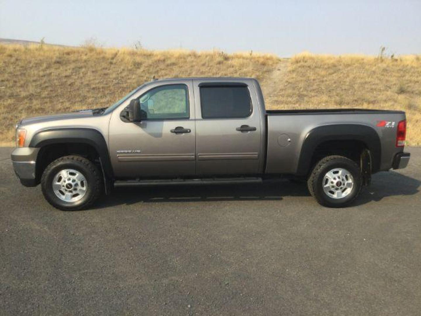 2012 Mocha Steel Metallic /Ebony GMC Sierra 2500HD SLE (1GT120C85CF) with an Duramax 6.6L V-8 diesel direct injection engine, 6-Speed Automatic transmission, located at 1801 Main Street, Lewiston, 83501, (208) 743-9371, 46.417065, -117.004799 - Photo#1