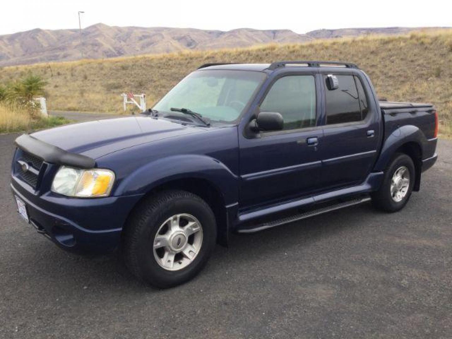 2004 Dark Blue Pearl Clearcoat Metallic /Medium Dark Flint/Dark Flint Ford Explorer Sport Trac XLT (1FMZU77K74U) with an 4.0L V6 DOHC 24V engine, 4 speed Automatic transmission, located at 1801 Main Street, Lewiston, 83501, (208) 743-9371, 46.417065, -117.004799 - Photo#1