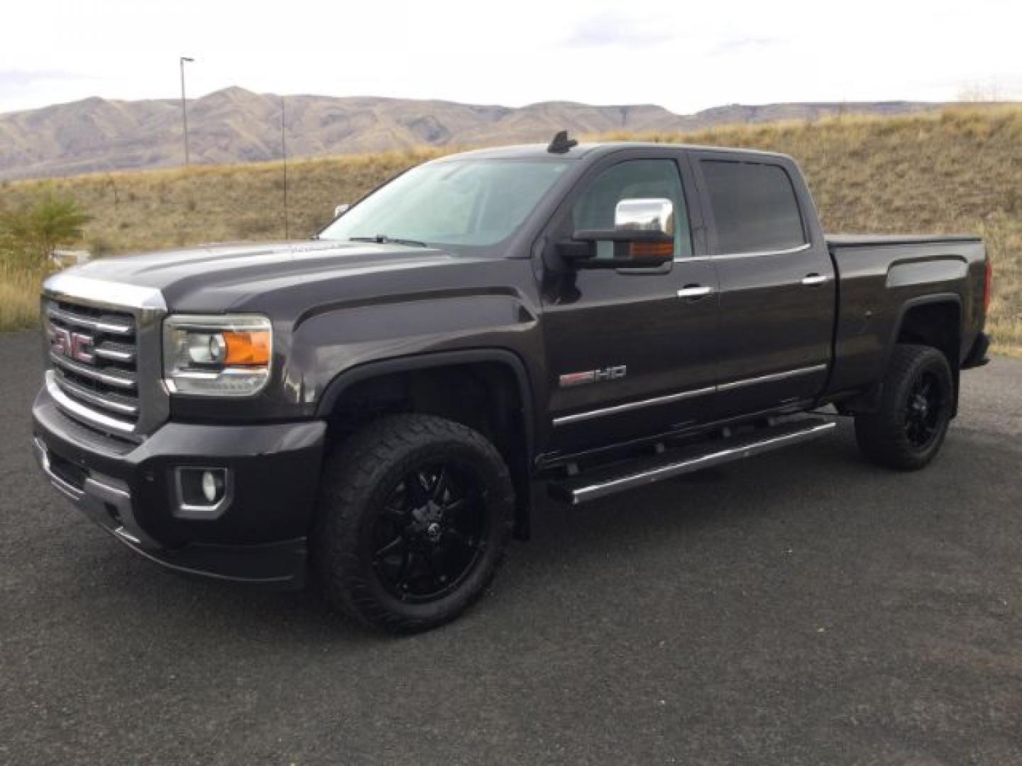 2015 Iridium Metallic /Dark Ash/Jet Black GMC 3500 Crew 4x4 SLT (1GT423C85FF) with an 6.6L V8 OHV 32V TURBO DIESEL engine, 6-Speed Automatic transmission, located at 1801 Main Street, Lewiston, 83501, (208) 743-9371, 46.417065, -117.004799- Photo#0