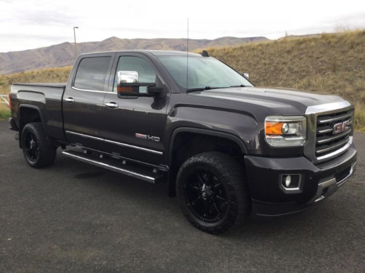 2015 Iridium Metallic /Dark Ash/Jet Black GMC 3500 Crew 4x4 SLT (1GT423C85FF) with an 6.6L V8 OHV 32V TURBO DIESEL engine, 6-Speed Automatic transmission, located at 1801 Main Street, Lewiston, 83501, (208) 743-9371, 46.417065, -117.004799- Photo#1
