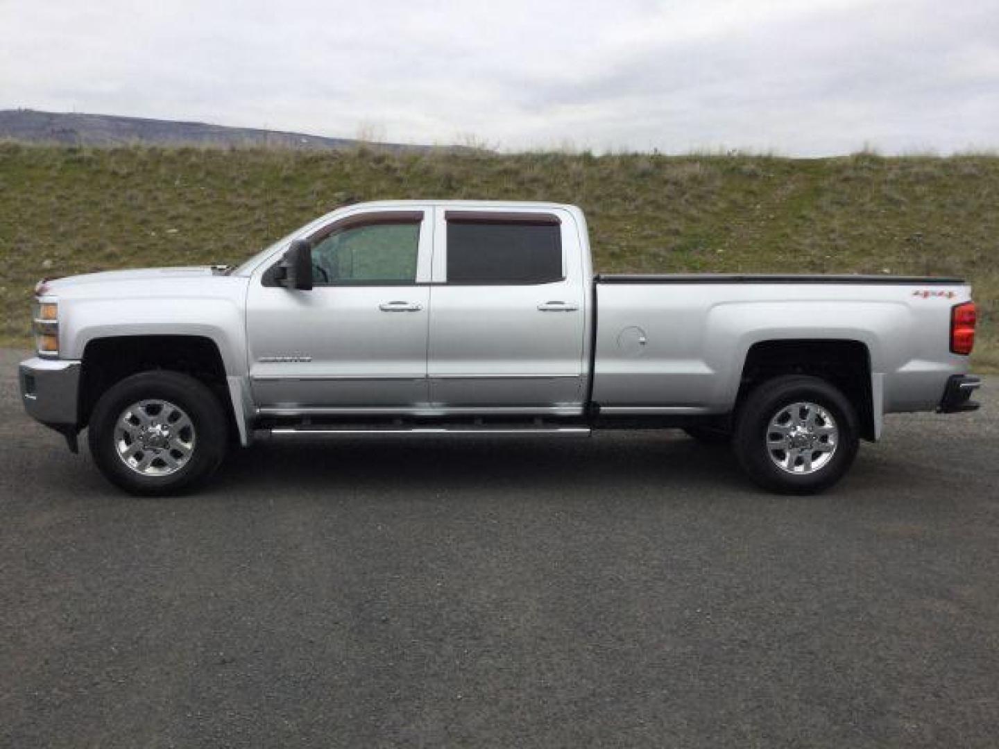 2015 Silver Ice Metallic /Jet Black Chevrolet Silverado 3500HD LTZ (1GC4K0C83FF) with an 6.6L V8 OHV 32V TURBO DIESEL engine, 6-Speed Automatic transmission, located at 1801 Main Street, Lewiston, 83501, (208) 743-9371, 46.417065, -117.004799 - Photo#1
