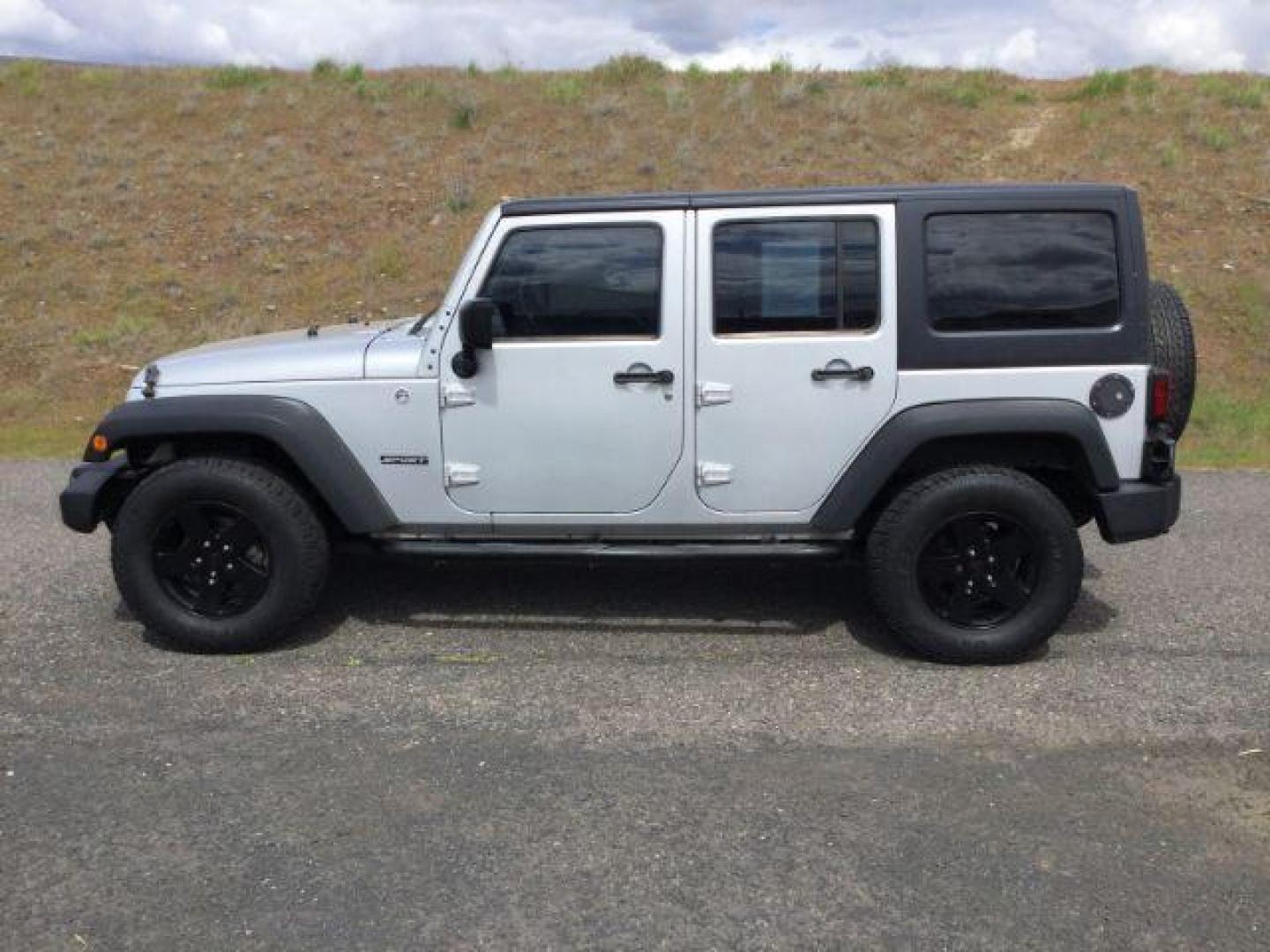 2012 Bright Silver Metallic Clearcoat /Black Jeep Wrangler Unlimited Sport (1C4BJWDG2CL) with an 3.6L V-6 DOHC engine, 5-Speed Automatic transmission, located at 1801 Main Street, Lewiston, 83501, (208) 743-9371, 46.417065, -117.004799 - Photo#1