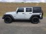 2012 Bright Silver Metallic Clearcoat /Black Jeep Wrangler Unlimited Sport (1C4BJWDG2CL) with an 3.6L V-6 DOHC engine, 5-Speed Automatic transmission, located at 1801 Main Street, Lewiston, 83501, (208) 743-9371, 46.417065, -117.004799 - Photo#1