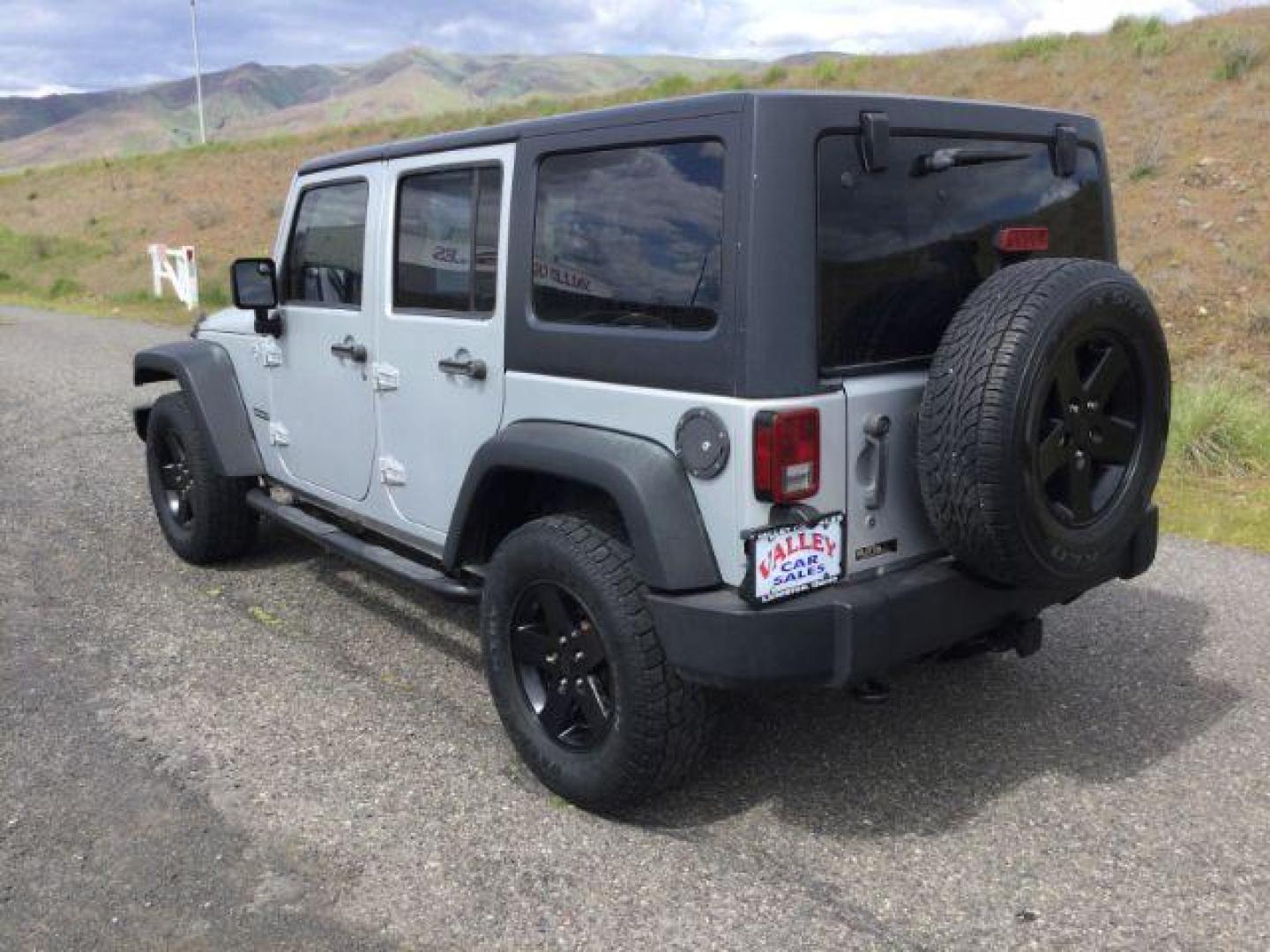 2012 Bright Silver Metallic Clearcoat /Black Jeep Wrangler Unlimited Sport (1C4BJWDG2CL) with an 3.6L V-6 DOHC engine, 5-Speed Automatic transmission, located at 1801 Main Street, Lewiston, 83501, (208) 743-9371, 46.417065, -117.004799 - Photo#2
