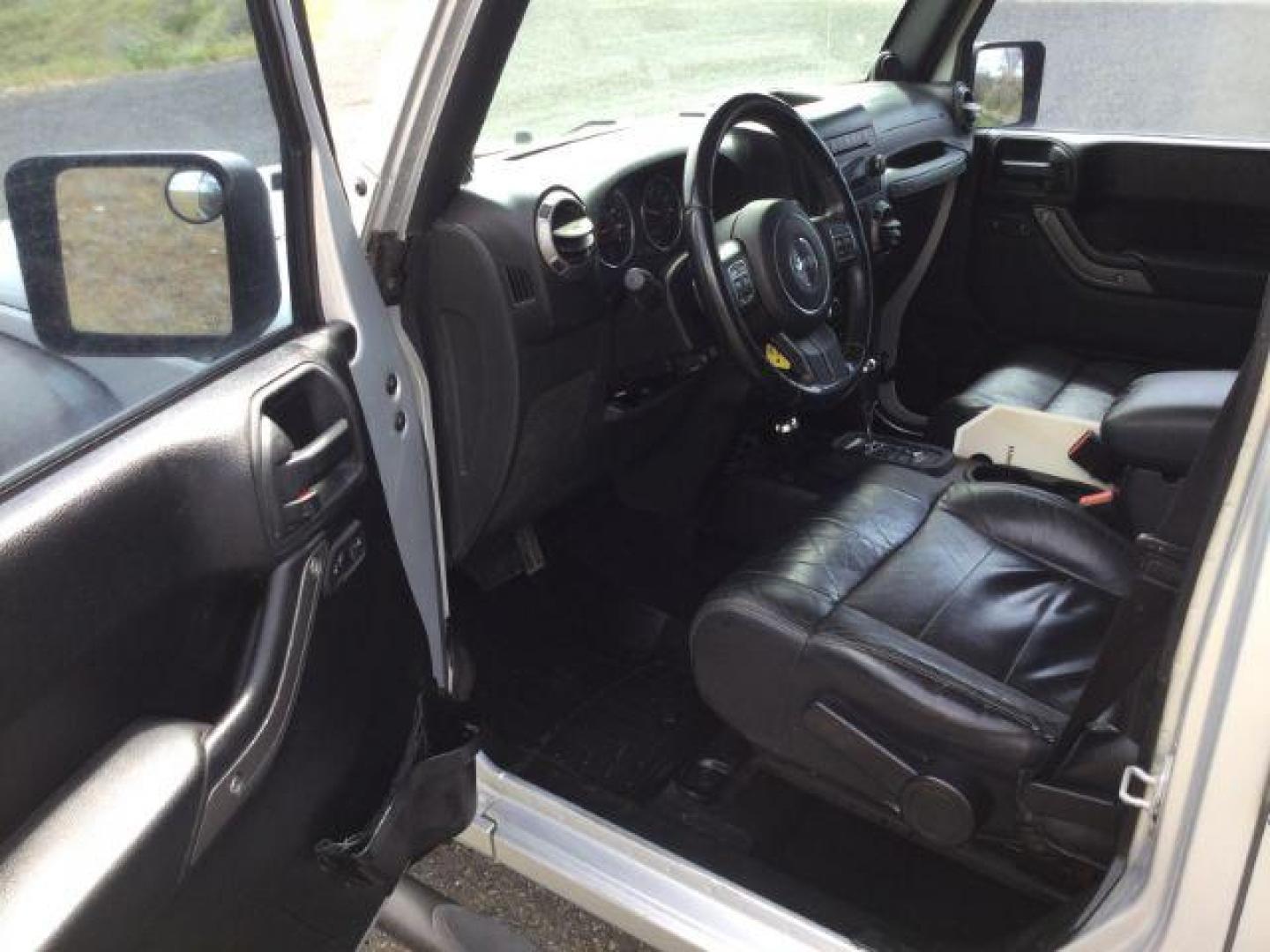 2012 Bright Silver Metallic Clearcoat /Black Jeep Wrangler Unlimited Sport (1C4BJWDG2CL) with an 3.6L V-6 DOHC engine, 5-Speed Automatic transmission, located at 1801 Main Street, Lewiston, 83501, (208) 743-9371, 46.417065, -117.004799 - Photo#4