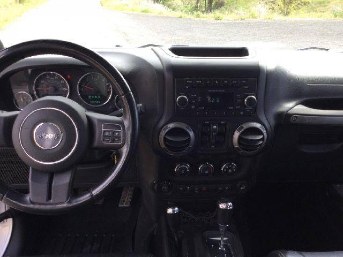 2012 Bright Silver Metallic Clearcoat /Black Jeep Wrangler Unlimited Sport (1C4BJWDG2CL) with an 3.6L V-6 DOHC engine, 5-Speed Automatic transmission, located at 1801 Main Street, Lewiston, 83501, (208) 743-9371, 46.417065, -117.004799 - Photo#5