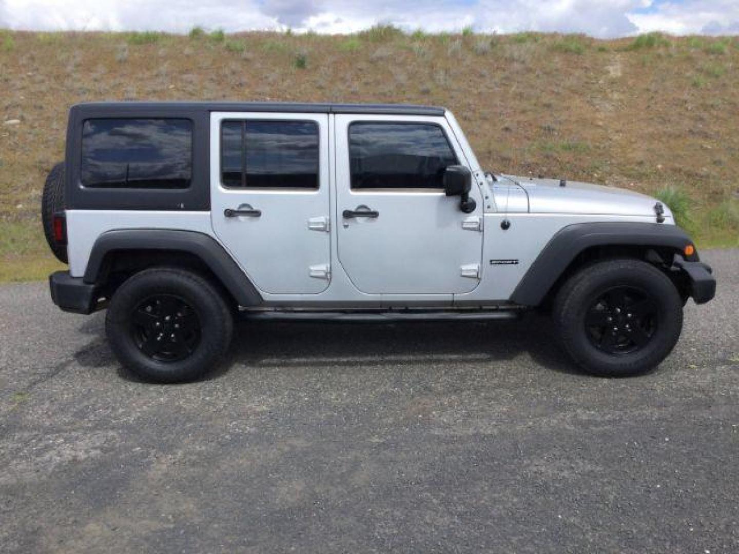 2012 Bright Silver Metallic Clearcoat /Black Jeep Wrangler Unlimited Sport (1C4BJWDG2CL) with an 3.6L V-6 DOHC engine, 5-Speed Automatic transmission, located at 1801 Main Street, Lewiston, 83501, (208) 743-9371, 46.417065, -117.004799 - Photo#12
