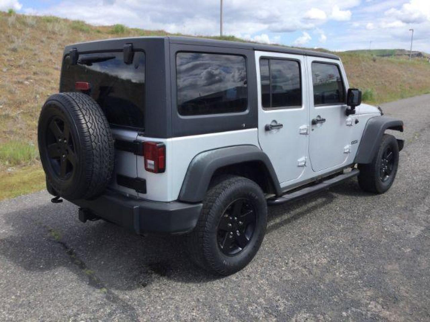 2012 Bright Silver Metallic Clearcoat /Black Jeep Wrangler Unlimited Sport (1C4BJWDG2CL) with an 3.6L V-6 DOHC engine, 5-Speed Automatic transmission, located at 1801 Main Street, Lewiston, 83501, (208) 743-9371, 46.417065, -117.004799 - Photo#14