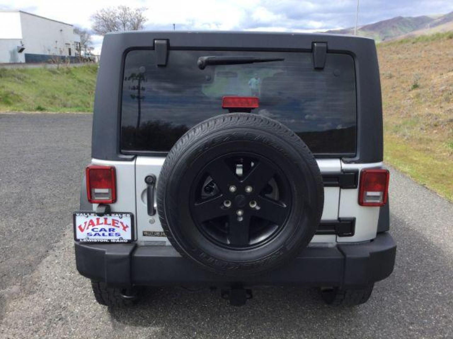 2012 Bright Silver Metallic Clearcoat /Black Jeep Wrangler Unlimited Sport (1C4BJWDG2CL) with an 3.6L V-6 DOHC engine, 5-Speed Automatic transmission, located at 1801 Main Street, Lewiston, 83501, (208) 743-9371, 46.417065, -117.004799 - Photo#16