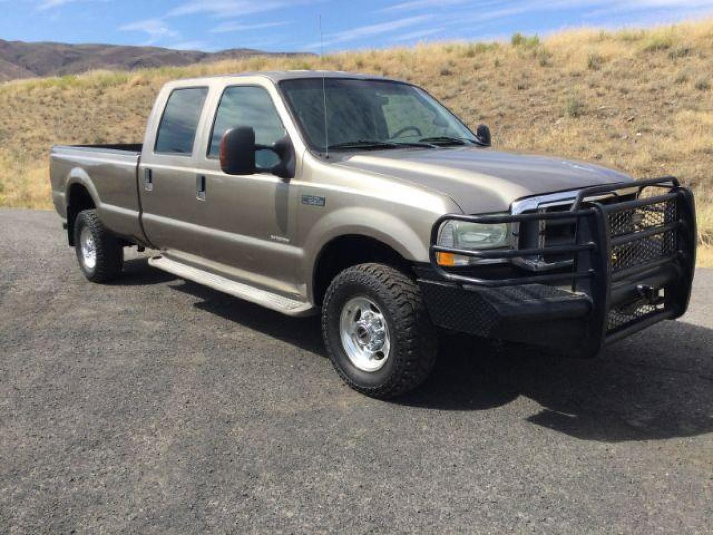 2004 Arizona Beige Metallic /Castano Leather Interior Ford F-350 Lariat Crew Cab Long Bed 4WD (1FTSW31P94E) with an 6.0L V8 OHV 32V TURBO DIESEL engine, 6-Speed Manual transmission, located at 1801 Main Street, Lewiston, 83501, (208) 743-9371, 46.417065, -117.004799 - Photo#0