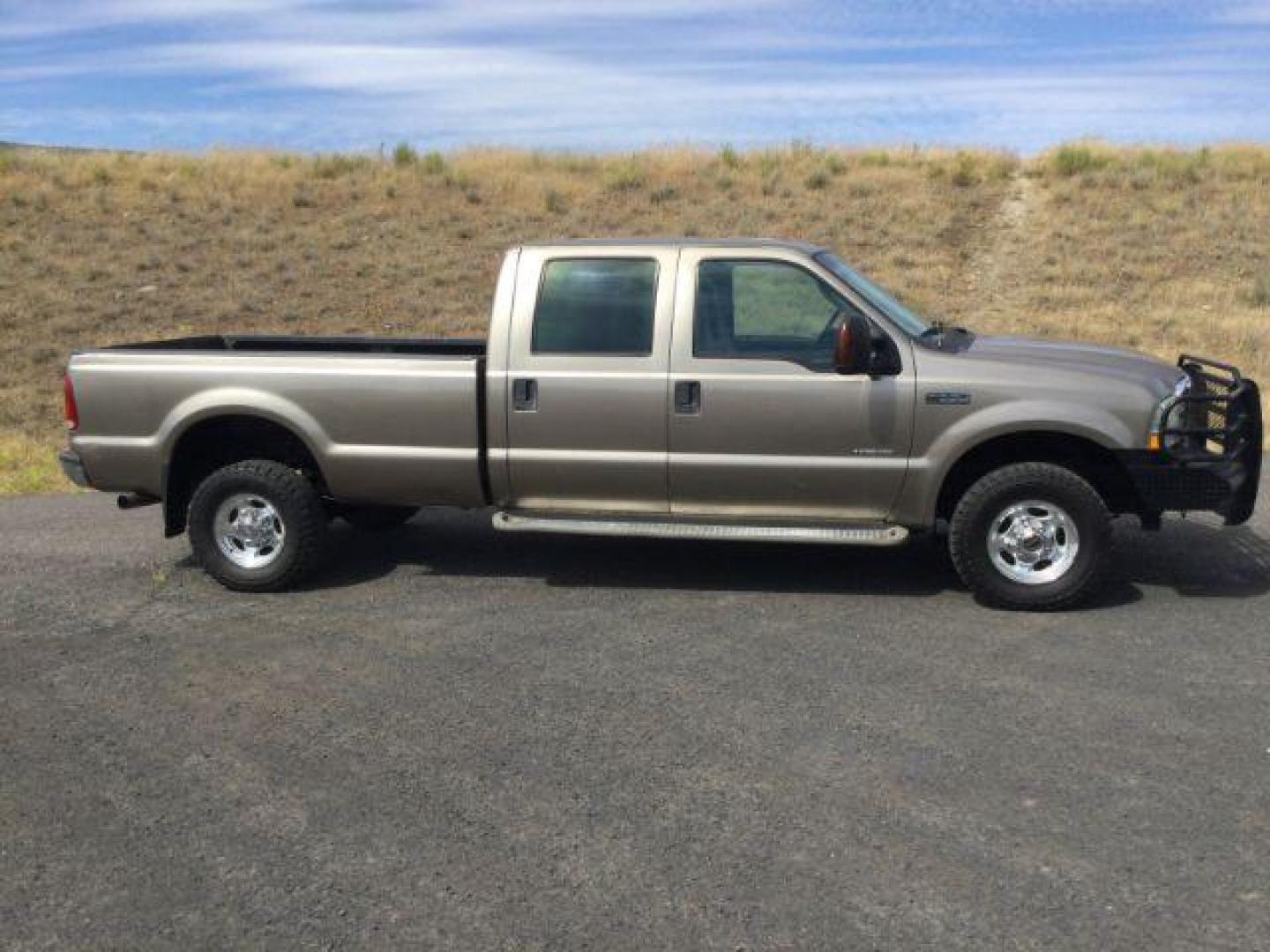 2004 Arizona Beige Metallic /Castano Leather Interior Ford F-350 Lariat Crew Cab Long Bed 4WD (1FTSW31P94E) with an 6.0L V8 OHV 32V TURBO DIESEL engine, 6-Speed Manual transmission, located at 1801 Main Street, Lewiston, 83501, (208) 743-9371, 46.417065, -117.004799 - Photo#1