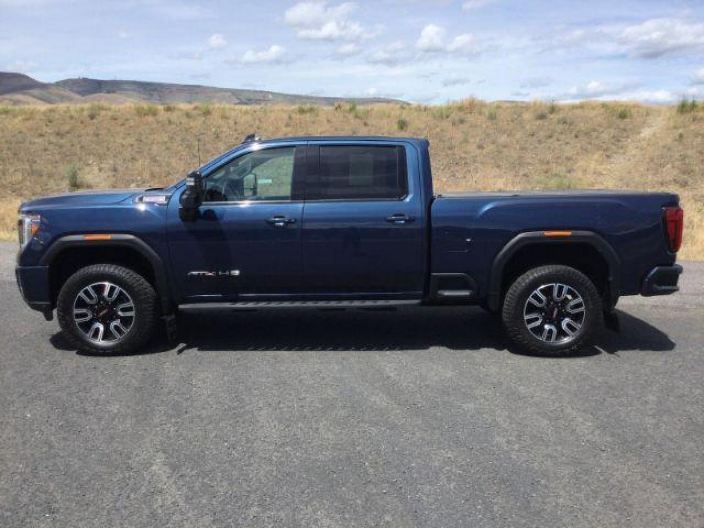 2022 Pacific Blue Metallic /Jet Black w/Kalahari Accents GMC Sierra 2500HD AT4 (1GT49PEY2NF) with an 6.6L V-8 gasoline direct injection engine, 10-speed automatic transmission, located at 1801 Main Street, Lewiston, 83501, (208) 743-9371, 46.417065, -117.004799 - Photo#2