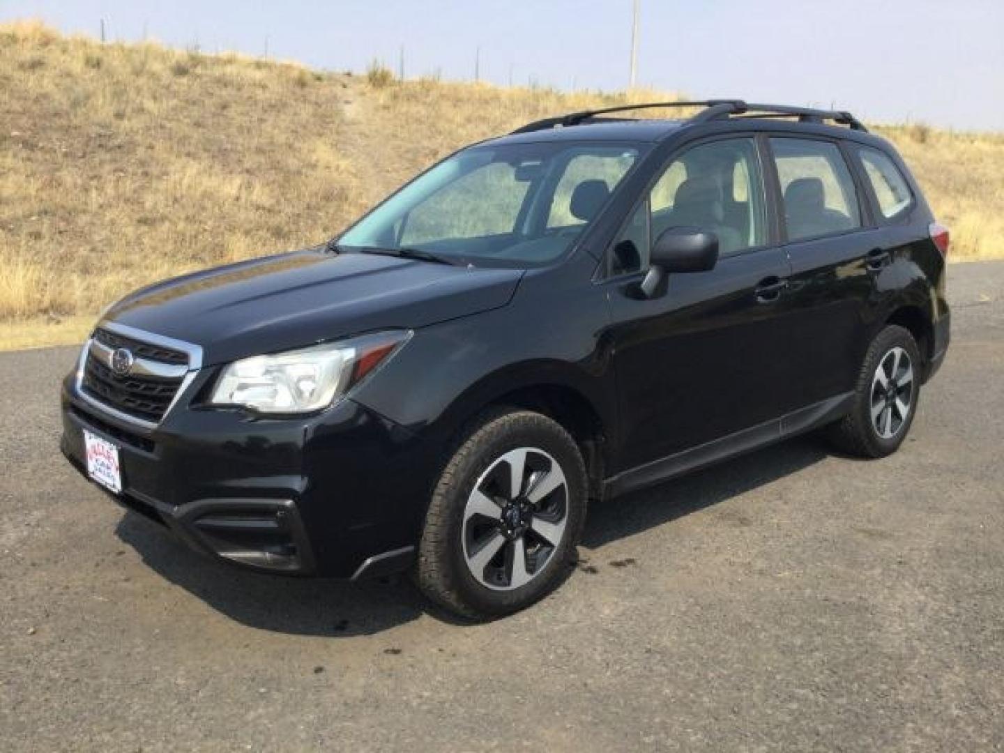 2018 Crystal Black Silica /Black Subaru Forester 2.5i (JF2SJABC3JH) with an 2.5L H-4 DOHC engine, CVT Automatic transmission, located at 1801 Main Street, Lewiston, 83501, (208) 743-9371, 46.417065, -117.004799- Photo#1