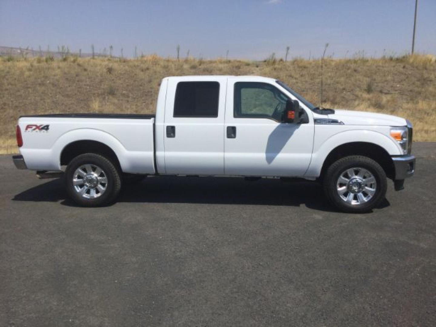 2015 Oxford White /Light Gray Leather Ford F-250 Crew Cab XLT 4x4 FX4 (1FT7W2B69FE) with an 6.2L V8 engine, 6-Speed Automatic transmission, located at 1801 Main Street, Lewiston, 83501, (208) 743-9371, 46.417065, -117.004799- Photo#2