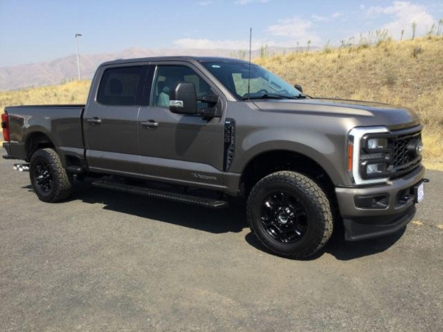 2023 Stone Grey Metallic /Medium Dark Slate Ford F-350 SD Crew Cab XLT 4x4 (1FT8W3BT9PE) with an 6.7L V8 OHV 16V DIESEL engine, 10 speed automatic transmission, located at 1801 Main Street, Lewiston, 83501, (208) 743-9371, 46.417065, -117.004799- Photo#1