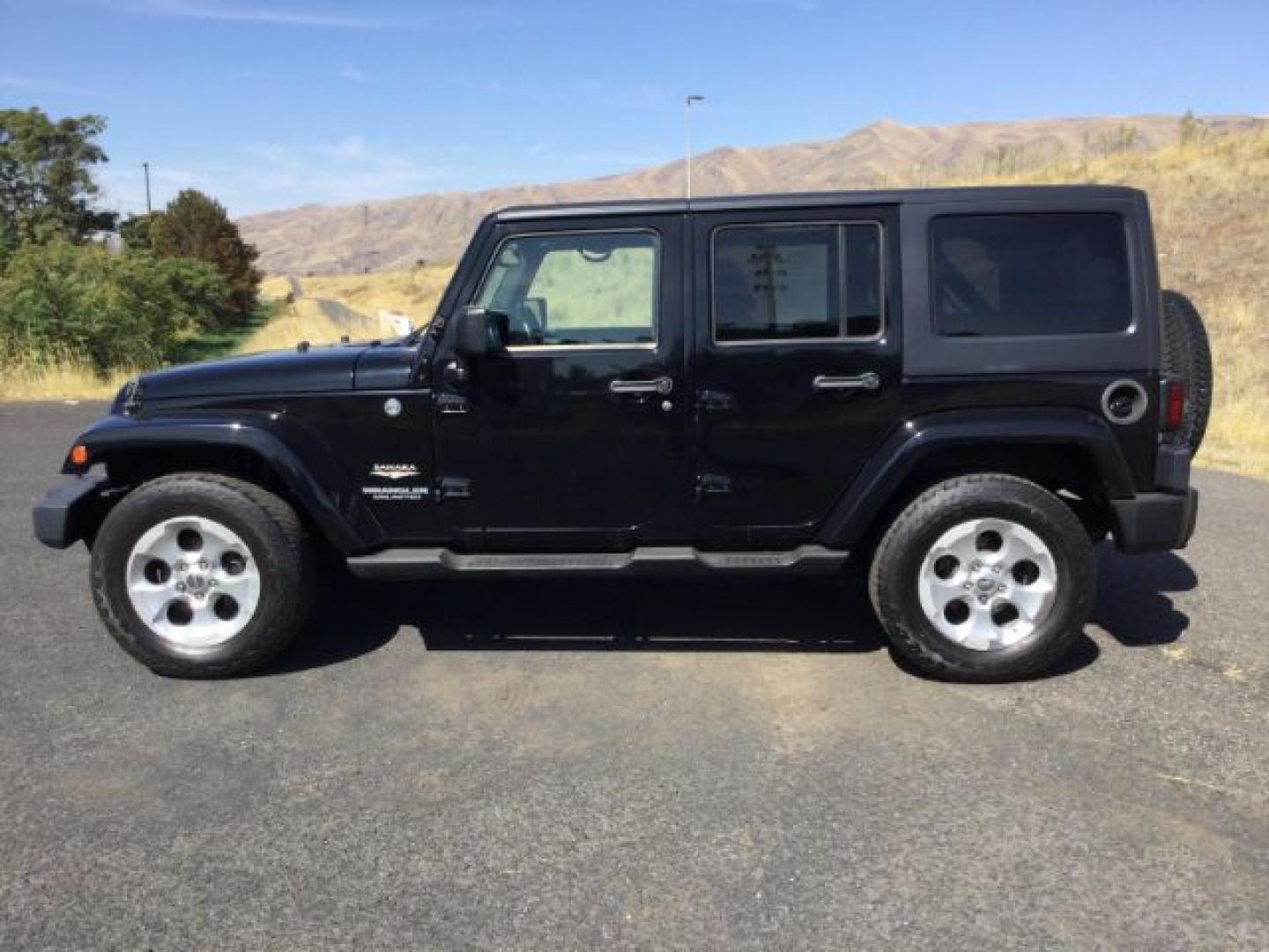 2013 Black /Black Jeep Wrangler Unlimited Sahara (1C4BJWEGXDL) with an 3.6L V-6 DOHC engine, 5-Speed Automatic transmission, located at 1801 Main Street, Lewiston, 83501, (208) 743-9371, 46.417065, -117.004799- Photo#1